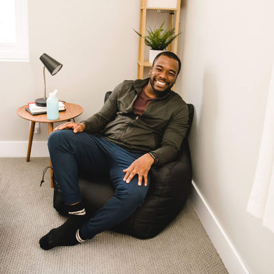 Man on black beanbag chair 