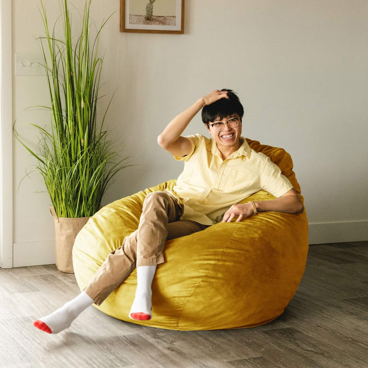 Yellow louts chair with man relaxing #color_mustard-plush