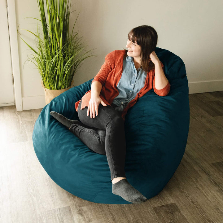 Woman on lotus bean bag chair filled with foam #color_teal-plush