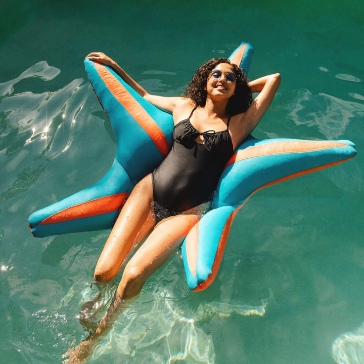 Woman Floating in water on Starfish Pool Float #color_fuzzy-peach